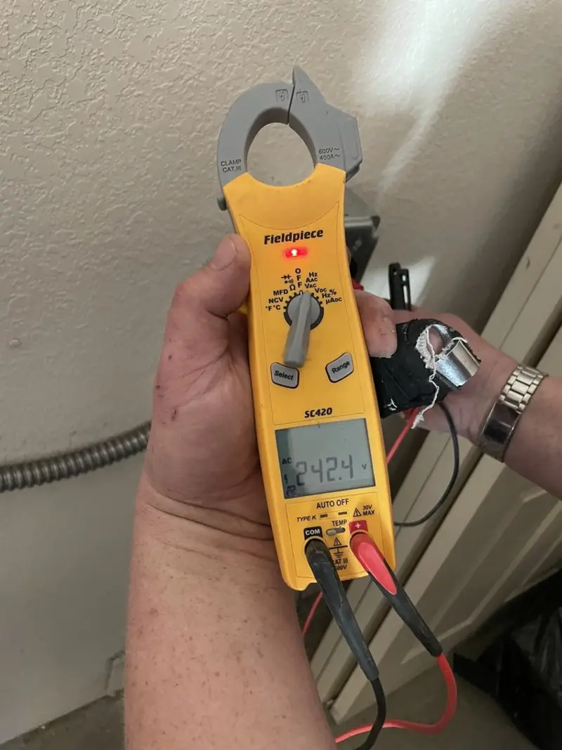 Voltage testing with clamp meter during Electrical Installation Services in West Bloomfield